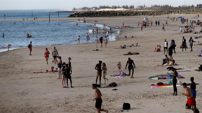 Beachgoers during hot weather at Glenelg Beach earlier this month. Picture: AAP Image/Kelly Barnes