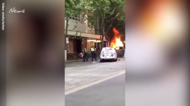 A knife-wielding confronts police in Melbourne CBD