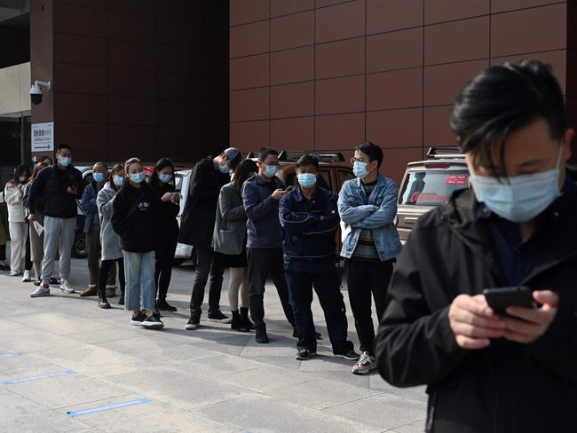 People line up to be tested for the Covid-19 booster shot at a hospital in Beijing on October. Picture: AFP