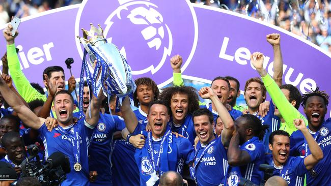 Gary Cahill of Chelsea and John Terry of Chelsea lift the Premier League Trophy.