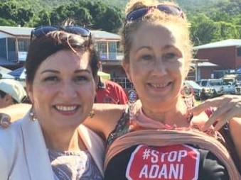 Queensland MP Leeanne Enoch later poses for a picture with the anti-Adani mine protester, but says she was blindsided as the woman revealed a protest t-shirt under her top. Picture: Facebook/StopAdaniCairns