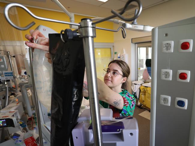 NICU nurse Tiana Crawford changes a fluid drip. Picture: David Caird