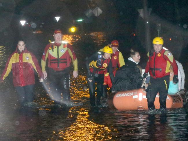 Residents being evacuated by Surf Rescue from their home in Mactier S, Narrabeen, after the lagoon flooded in February, 2020. Picture: Damian Shaw