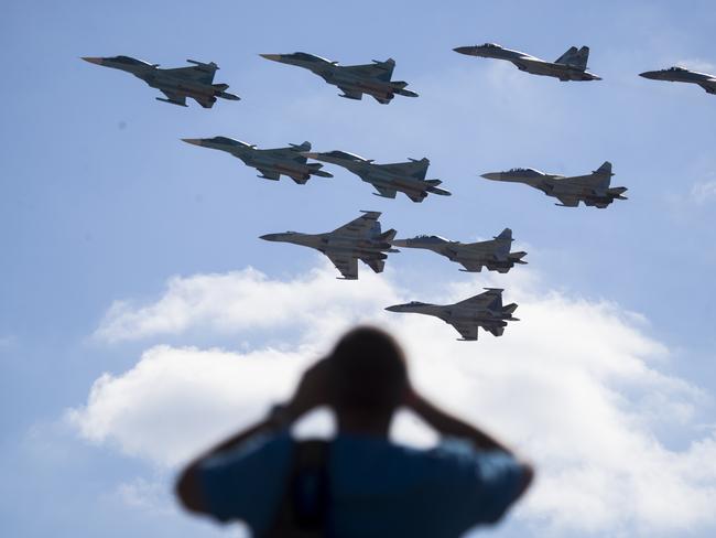 A man watches Russian military jets performing in Alabino, outside Moscow, Russia. The Russian military says major war games, the Zapad (West) 2017 manoeuvres will not threaten anyone. Picture: AP