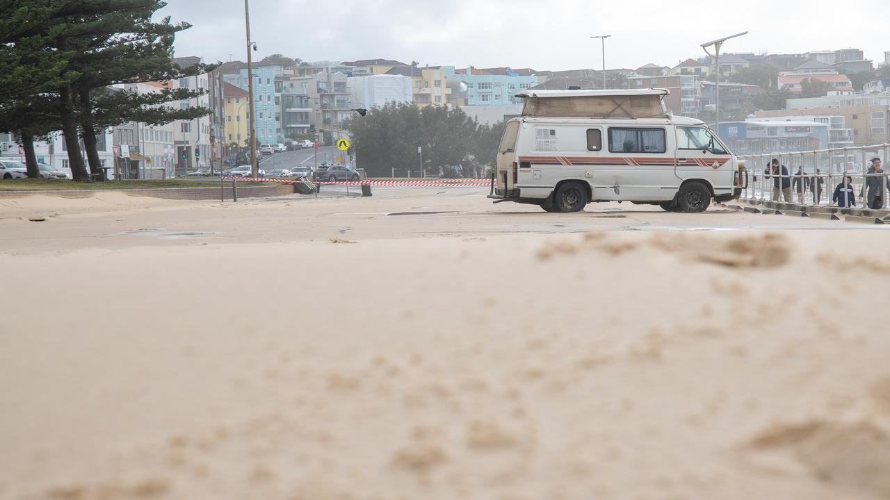 Sand covers the car park and foot paths at Bondi on Saturday after heavy winds. Picture Thomas Lisson