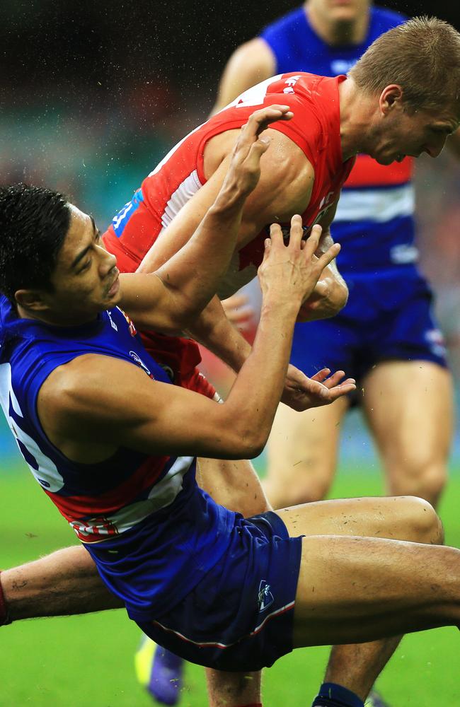 Swans' Kieren Jack bumps Western Bulldogs' Lin Jong out and off the ball. Picture: Toby Zerna.