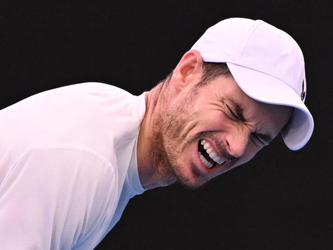 Britain's Andy Murray grabs his back in pain as he plays against Spain's Roberto Bautista Agut during their men's singles match on day six of the Australian Open tennis tournament in Melbourne on January 21, 2023. (Photo by WILLIAM WEST / AFP) / -- IMAGE RESTRICTED TO EDITORIAL USE - STRICTLY NO COMMERCIAL USE --