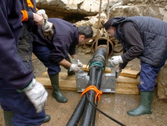 Italian technicians manipulate a section of the underwater internet cables.