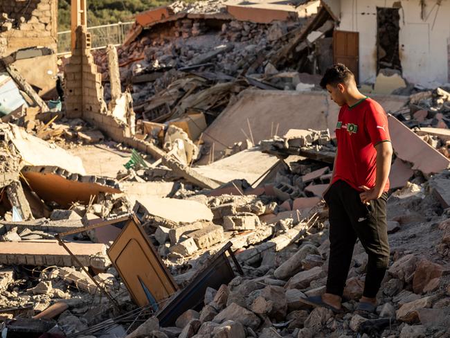 TOPSHOT - A man looks at the rubble of homes in the village of Talat N'Yacoub, south of Marrakech on September 11, 2023. The quake killed at least 2,122 people, injured more than 2,400 others, and flattened entire villages. (Photo by FADEL SENNA / AFP)