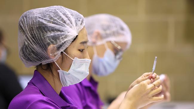 Clinical staff label drawn up AstraZeneca COVID-19 syringes at the Claremont Showgrounds COVID-19 Vaccination Clinic in Perth. Picture: Getty Images