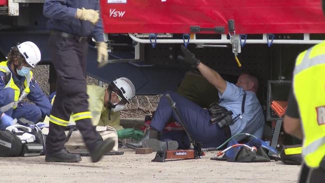 A man has been freed from under a truck at a service station, escaping with minor injuries. Picture: TNV