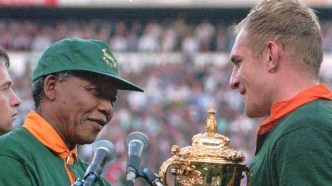 Francios Pienaar receives the Rugby World Cup from Nelson Mandela in 1995.