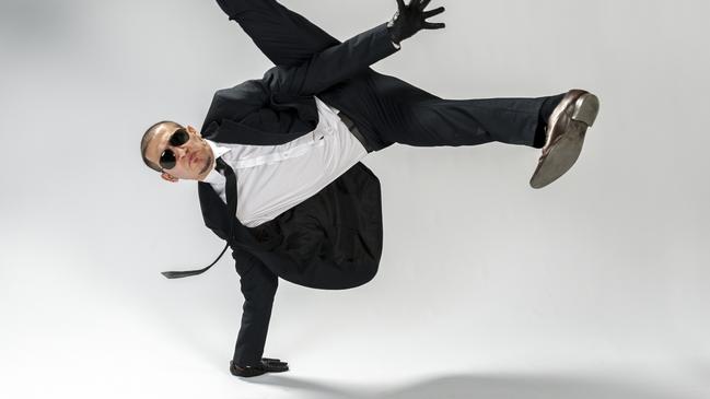 breakdancing businessman performing single handstand looking cool at the camera with sunglasses on, white background. Studioshot. dancing, generic, funny