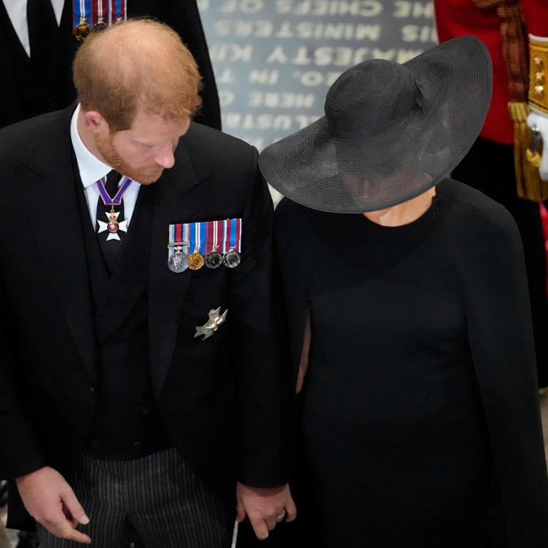 Harry and Meghan appeared to hold hands as they left the Abbey together (Photo by Frank Augstein / POOL / AFP)