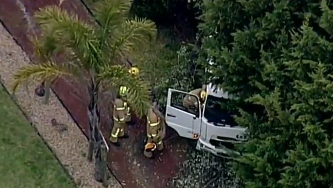 A woman has died after being struck by a truck carrying an excavator in Donvale. Image: Nine News