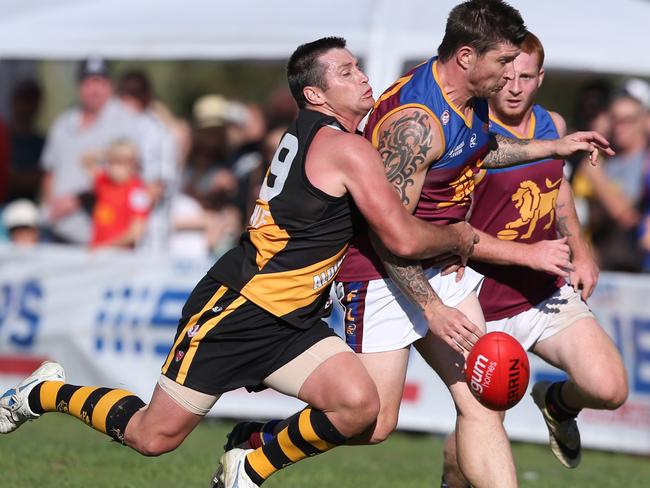 Shane Crawford about to tackle an O'Sullivans Beach/Lonsdale player at Aldinga Oval. Picture: Tait Schmaal