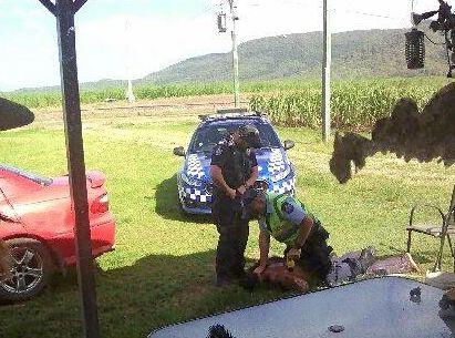 The moment when Queensland Police arrested Brian Tapim on the front porch of an Oakenden property.