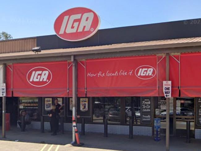 A man allegedly threatened an IGA worker with a crowbar and stole a packet of cigaretteses