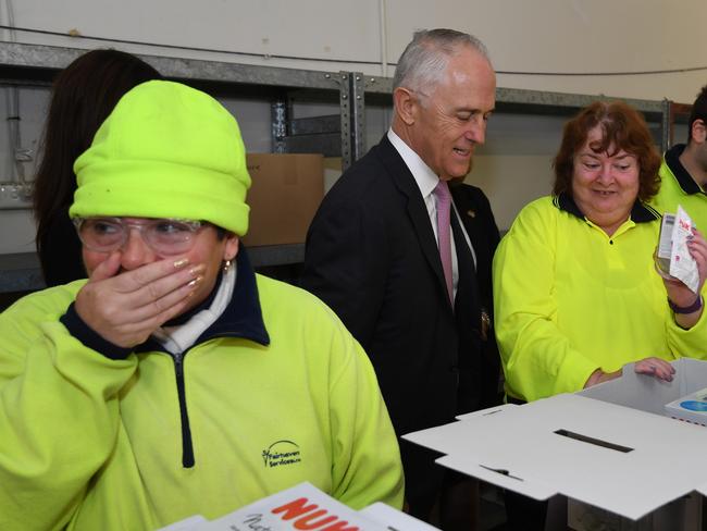 Prime Minister Malcolm Turnbull meets workers with disabilities in the up-cycling workshop at Fairhaven Shopping Centre in Gosford, Friday, May, 25 with NSW the first state to officially sign up to the full rollout of the National Disability Insurance Scheme. (AAP Image/Dean Lewins)