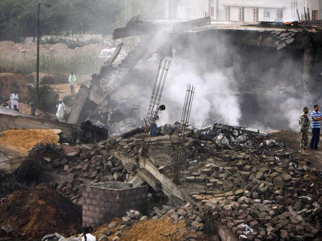 Pakistani army officials inspect the site the plane crash in Karachi. Picture: AP