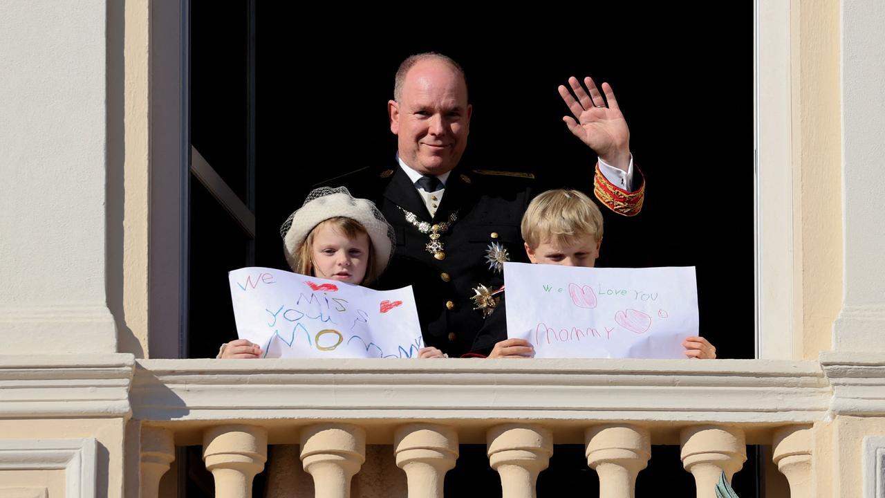 Prince Albert II of Monaco, Princess Gabriella and Prince Jacques stand with a message for Princess Charlene at the balcony of Monaco Palace in November. Picture: Valery HACHE / AFP