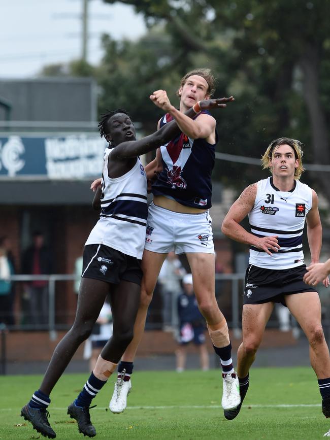 Domanic Akuei and Jacob Edwards contest the ball. Picture: Steve Tanner