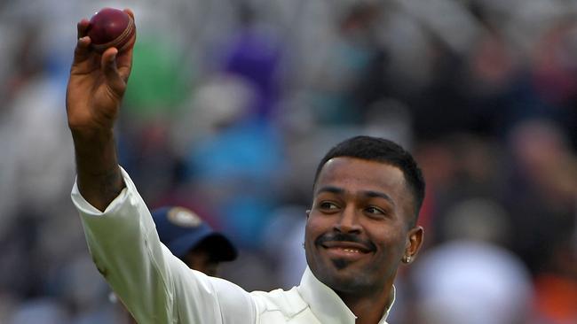 India's Hardik Pandya walks off with the ball after taking five wickets during play on the second day of the third Test cricket match between England and India at Trent Bridge in Nottingham. (Photo by Paul ELLIS / AFP)