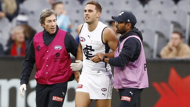 Cuningham in the hands of medical staff after suffering his knee injury.