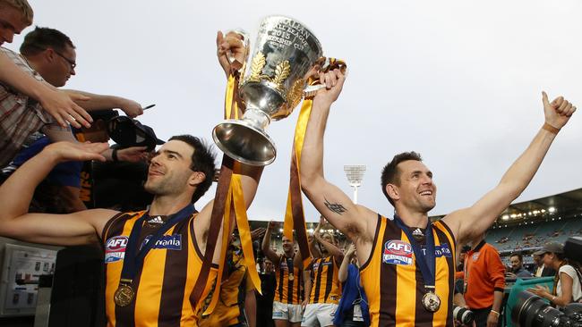 Hawthorn’s Jordan Lewis (left) won four premierships after being selected at Pick 7. His teammate Luke Hodge (right) won four flags after being picked up with Pick 1. Picture: David Caird.