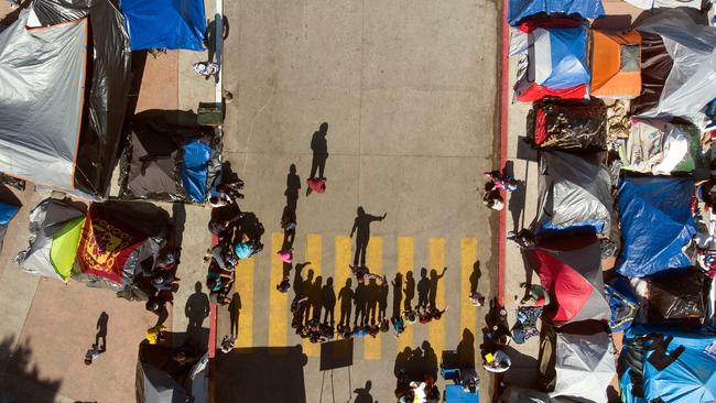 Aerial view of migrant children attending a class at a migrants camp where they wait for US authorities to allow them to start their migration process outside El Chaparral crossing port in Tijuana, Baja California state, Mexico. Picture: Guillermo Arias / AFP