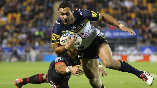 Cowboy Justin O'Neill crashes through the tackle of Warrior Ken Maumalo to score a try in round 24.