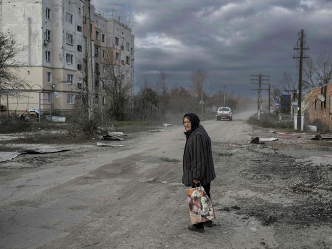 TOPSHOT - An old woman walks in the Kherson region village of Arkhanhelske on November 3, 2022, which was formerly occupied by Russian forces. (Photo by BULENT KILIC / AFP)