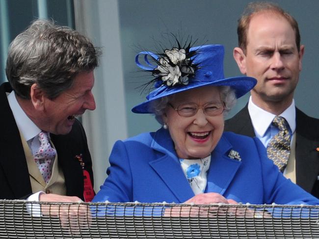 Queen Elizabeth II standing next to Prince Edward, Earl of Wessex smiles from the royal balcony as she looks down on the winning horse in the Derby race on Derby Day, at Epsom in Surrey 02/06/2012 the first official day of Britain’s Queen Elizabeth II’s Diamond Jubilee celebrations. Picture: AFP
