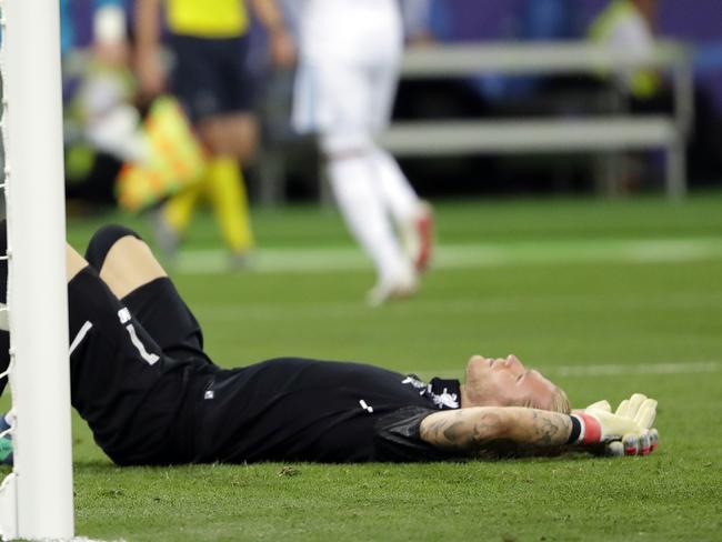 FILE - In this May 26, 2018, file photo, Liverpool goalkeeper Loris Karius lies on the field after during the Champions League final soccer match at the Olimpiyskiy Stadium in Kiev, Ukraine. Doctors concluded five days after the match Karius sustained a concussion that would have affected his performance. Concussion substitutions could be trialed in English soccer next season after proposals were presented to the gameâ€™s lawmakers. The Premier League has given an initial suggestion to the rule-making International Football Association Board proposing that the current three-minute period to assess players for concussion would be used to determine if a â€œhead injury replacementâ€ is required. (AP Photo/Sergei Grits, File)