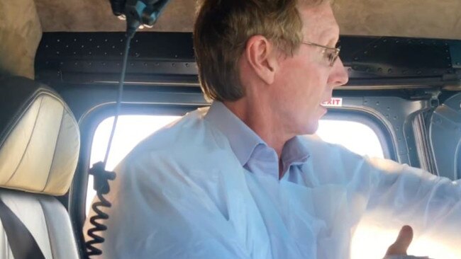 Dr John McIntosh putting on PPE in the helicopter. Picture: supplied