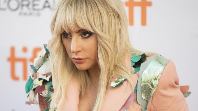 Lady Gaga poses for photographers outside the Princess of Wales Theatre in Toronto.