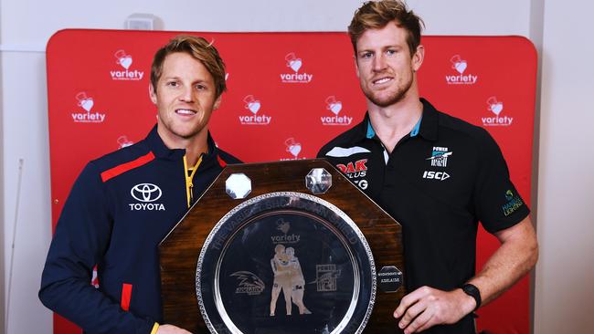 Crows co-captain Rory Sloane and Power co-captain Tom Jonas pose with the Variety Cup Showdown Shield at Variety Club Headquarters on Monday morning. Picture: Image AAP/Mark Brake