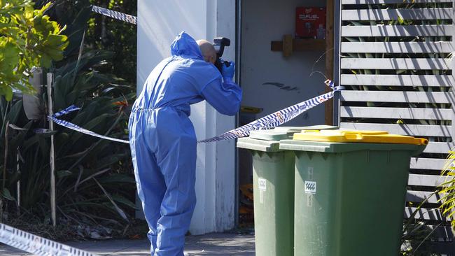 Forensic investigators at a home in Coomera after a deadly house fire. Picture: Tertius Pickard
