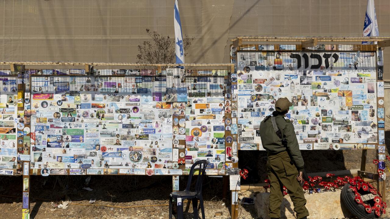 An Israeli soldier looks at a memorial wall for civilians and soldiers who have been killed since the deadly Hamas attacks. Picture: Getty