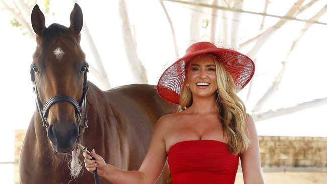 Grace Hayden, in a hat that is bang on trend – and with a touch of gold accessories – with international horse Lazzat. Picture: Jonathan Ng