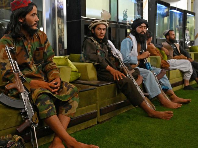 Taliban fighters lounge inside the mansion. Picture: AFP