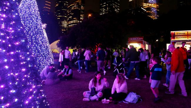 People enjoy the 'Digital Christmas Forest' at the Royal Botanic Gardens this year. Picture: Lisa Maree Williams/Getty Images