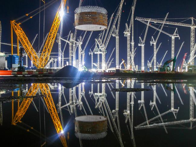 A crane lifts a prefabricated steel containment ring into position at the nuclear Reactor Unit 1, at Hinkley Point C nuclear power station construction site, near Bridgwater, U.K., on Thursday, Dec. 17, 2020. The world's largest crane, affectionately known as Big Carl, hoisted the first of three massive steel rings that will encase one of the reactors atÃÂ Electricite de France SA's nuclear construction site in the U.K., a key milestone in getting the project completed on time. Photographer: Luke MacGregor/Bloomberg via Getty Images