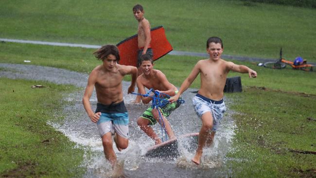 Ballina’s Jonah Verus, Sunny Seberry and Brody Ross play as rain lashes the far north coast. Picture: Jason O'Brien