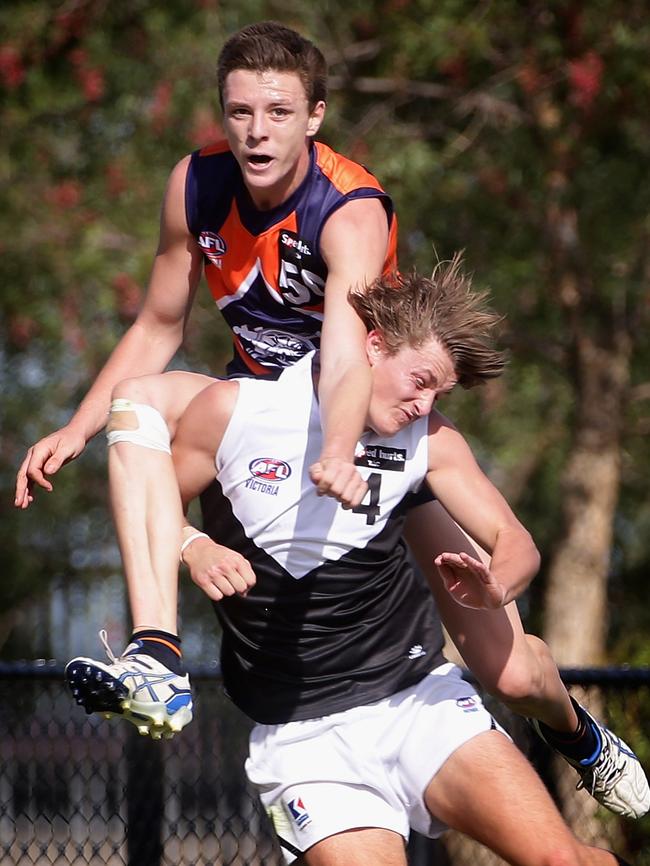 Matt Crouch, playing in a TAC Cup match for the Rebels, hip-and-shoulders Jake Lever of the Cannons in 2013.