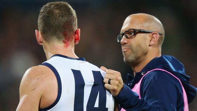 ‘Nah, I’m right mate, more possessions to gather’. Selwood in the hands of a trainer. Picture: Getty Images