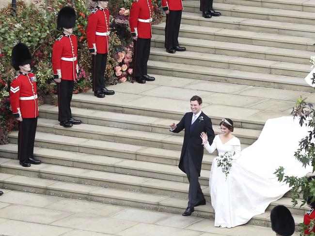 The newlyweds walk down the West Steps as they leave St George's Chapel, Windsor Castle. Picture: AP