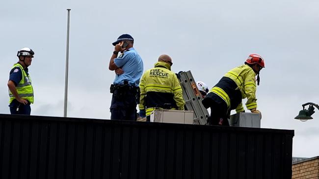 Police and fire brigades officers on the building roof. Picture: TNV