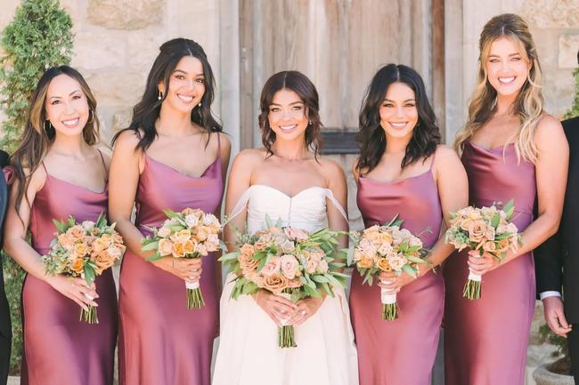 Image credit: wedding photography by John & JosephVanessa HudgensFinally tying the knot after a number of postponements in 2022, Sarah Hyland married Wells Adams in a romantic vineyard wedding in Santa Ynez, California, with Vanessa Hudgens by her side as one of her four bridesmaids in coordinated mauve slip dresses. In a sentimental post made following the wedding, Hudgens wrote in tribute to Hyland and her nuptials: “Words can’t express how happy I am for you. I am so proud to be your friend and bridesmaid. I’ll love you forever.” 