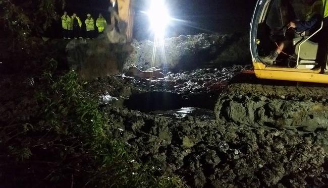 An excavator was used to dig mud and silt out of the dam before the firefighters wearing safety harnesses went in. Picture: Picton Fire and Rescue Station Facebook